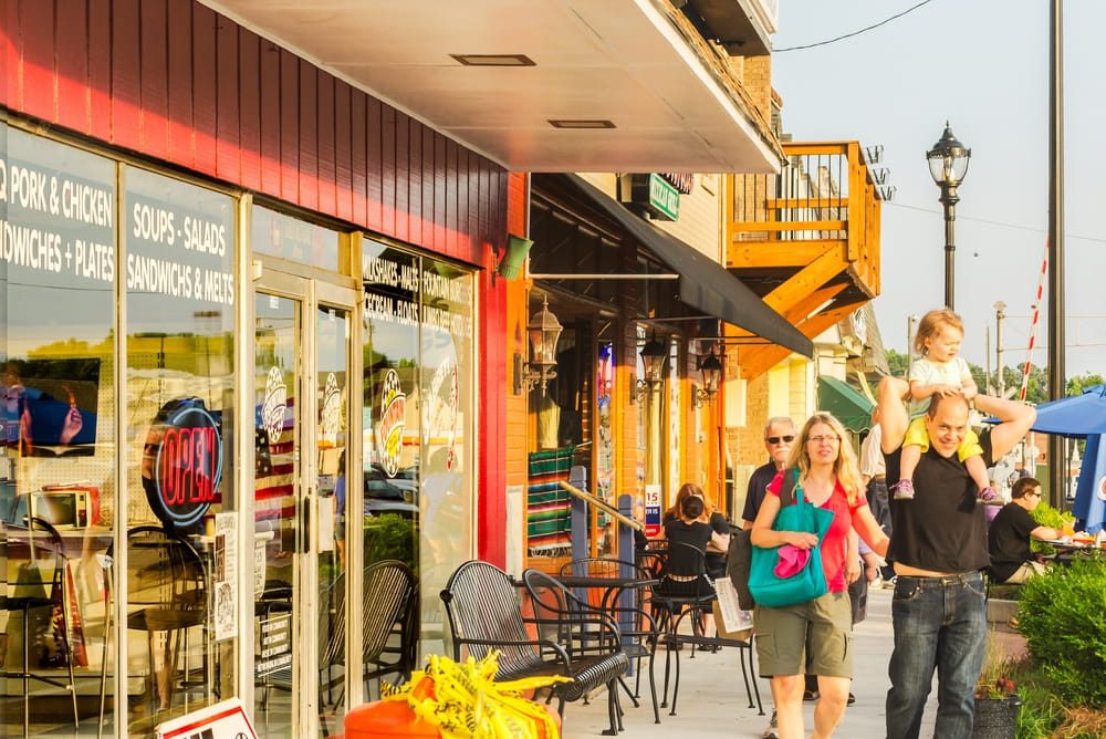 People-walk-down-Main-Street-during-the-Tucker-Farmers-Market-in-downtown-Tucker-Georgia